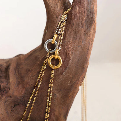 Collier double chaîne dorée avec anneau argenté